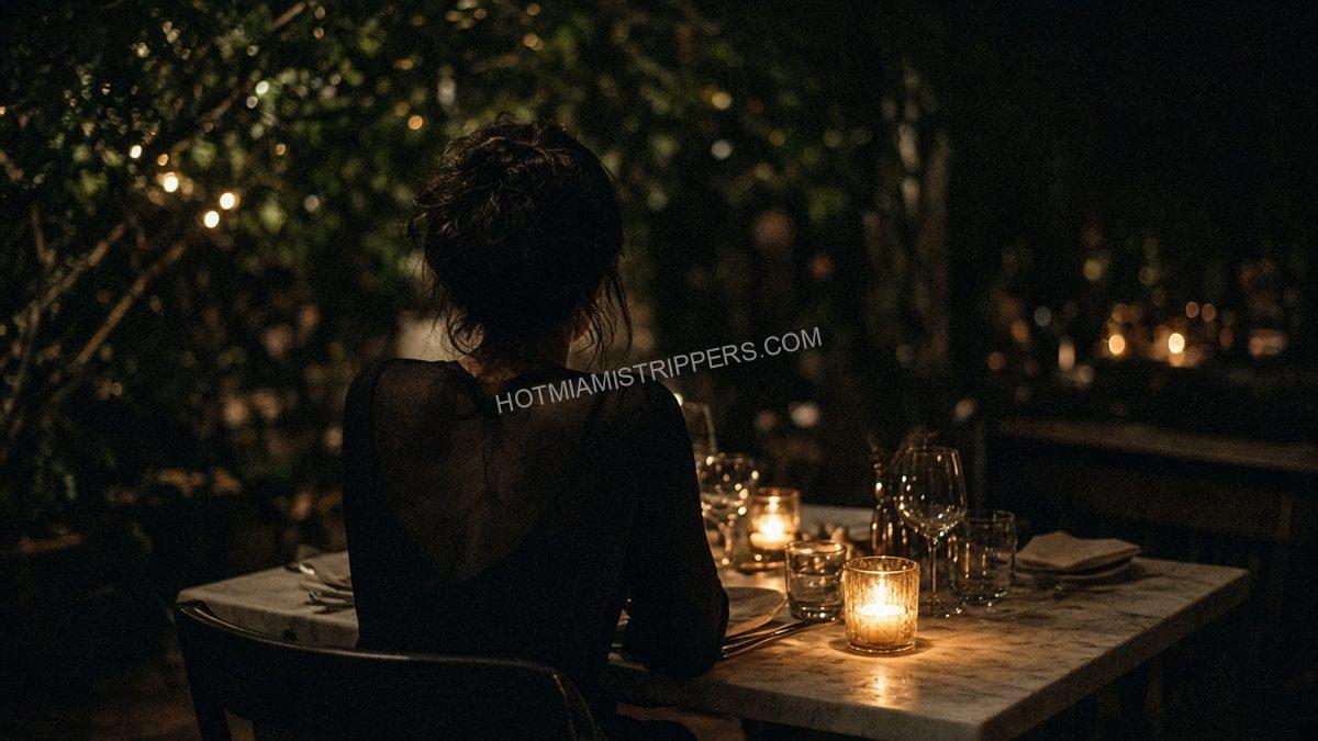 person seen from behind at a dining table with candles