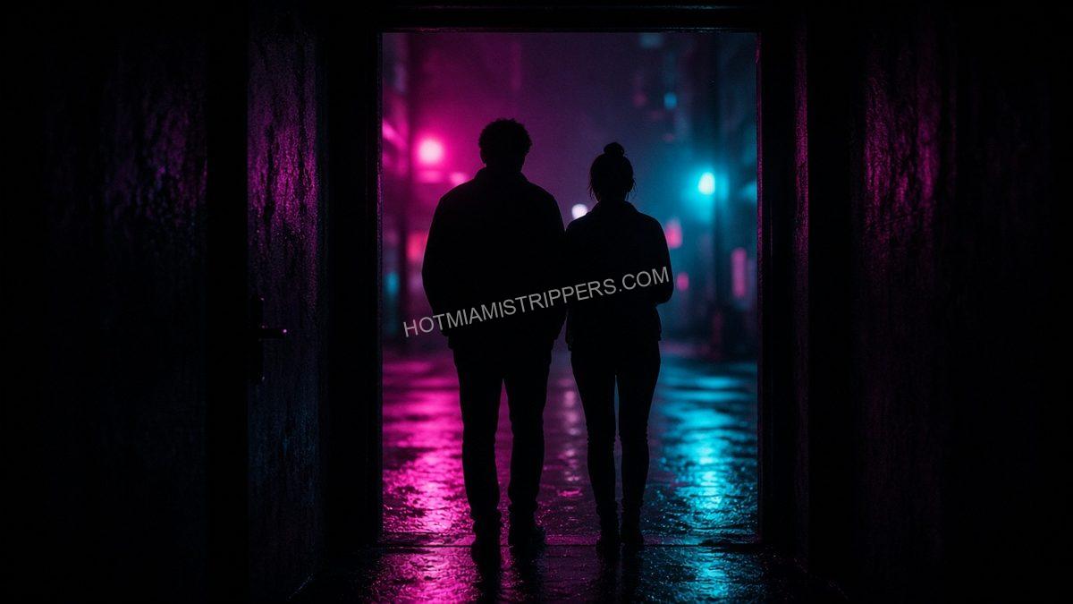 two silhouettes standing in a doorway under neon light